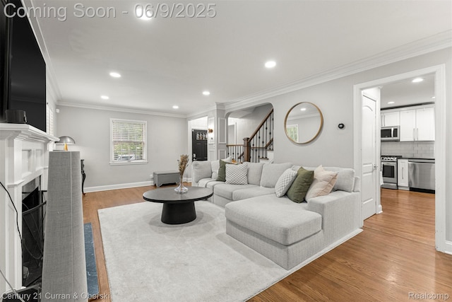 300 S Melborn St, Dearborn, MI 48124 - living room with light wood-style flooring, recessed lighting, stairs, a fireplace, and crown molding