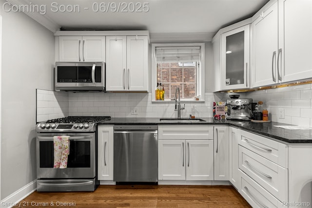 300 S Melborn St, Dearborn, MI 48124 - kitchen with stainless steel appliances, a sink, ornamental molding, and white cabinetry