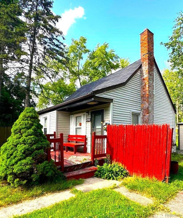 4598 Lodewyck St, Detroit, MI 48224 - rear view of property featuring a chimney and a wooden deck
