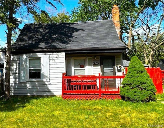 4598 Lodewyck St, Detroit, MI 48224 - view of front of home featuring a porch, a front lawn, and a chimney