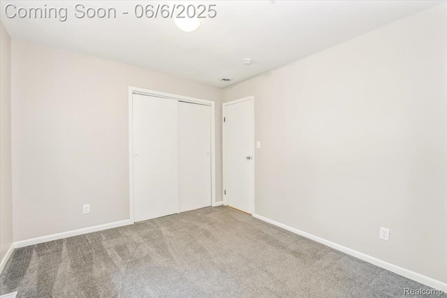 22850 Sumpter Rd, Belleville, MI 48111 - unfurnished bedroom with carpet floors, baseboards, and a closet