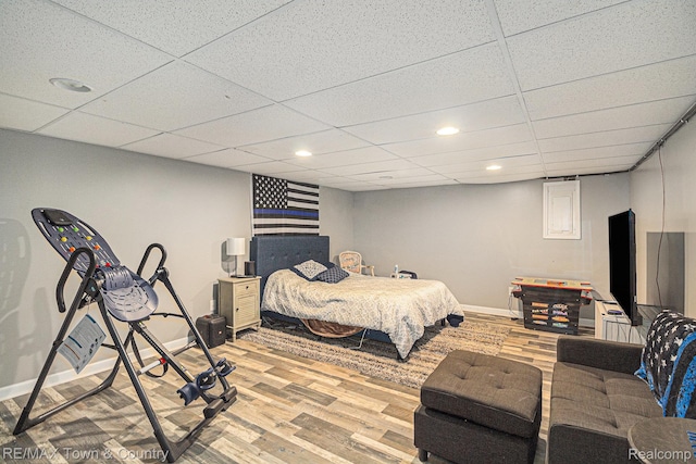 813 Birchwood Dr, Flushing, MI 48433 - bedroom with baseboards, wood finished floors, a paneled ceiling, and recessed lighting