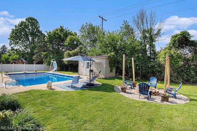 813 Birchwood Dr, Flushing, MI 48433 - view of pool with an outdoor structure, a patio, a fire pit, a water slide, and a storage structure