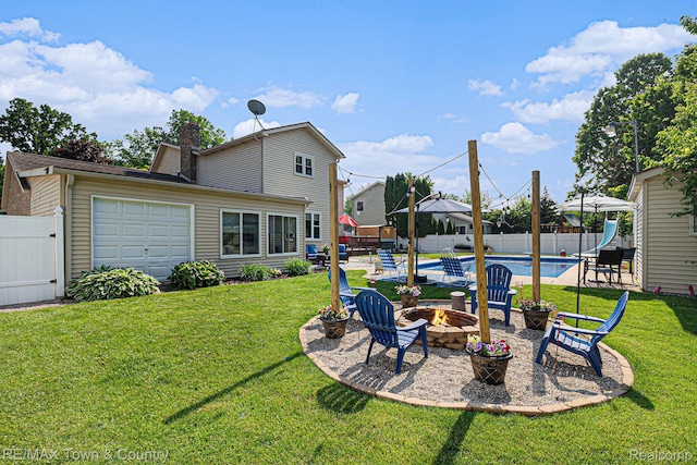 813 Birchwood Dr, Flushing, MI 48433 - view of yard with an outdoor fire pit, an attached garage, and a patio area