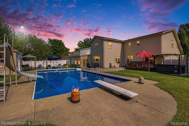 813 Birchwood Dr, Flushing, MI 48433 - view of swimming pool featuring a hot tub, a diving board, a water slide, and a patio area