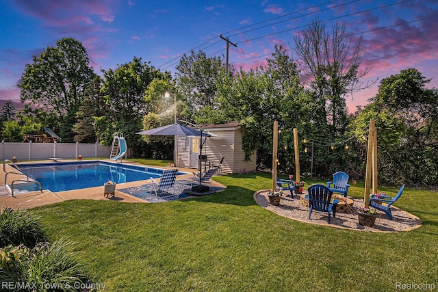 813 Birchwood Dr, Flushing, MI 48433 - view of swimming pool featuring an outbuilding, a patio area, a fire pit, and a water slide