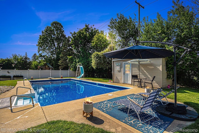 813 Birchwood Dr, Flushing, MI 48433 - view of pool with an outbuilding, a patio, a water slide, and a storage structure