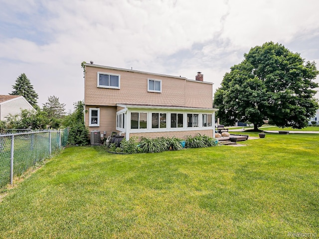 1725 Windingway Dr, Wixom, MI 48393 - rear view of property with a chimney and cooling unit