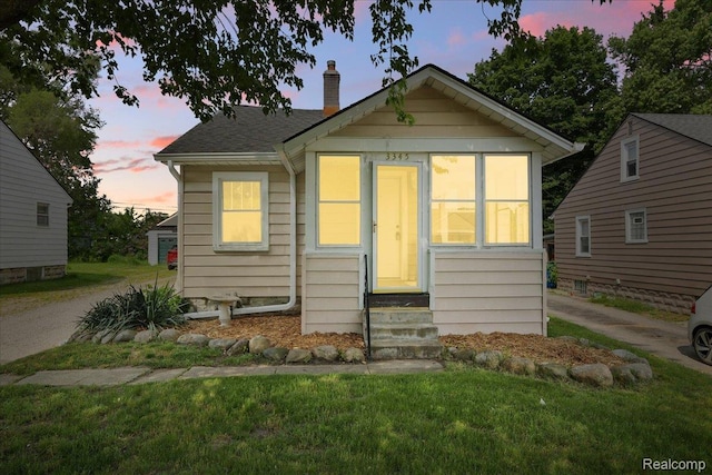 3345 Curwood St, Bloomfield Hills, MI 48329 - bungalow-style home with entry steps, a chimney, a front yard, and roof with shingles