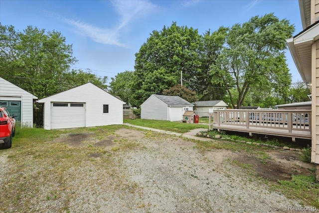 3345 Curwood St, Bloomfield Hills, MI 48329 - view of yard featuring an outdoor structure, a detached garage, a deck, and driveway