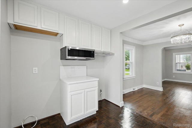 3345 Curwood St, Bloomfield Hills, MI 48329 - kitchen featuring stainless steel microwave, white cabinets, arched walkways, and light countertops