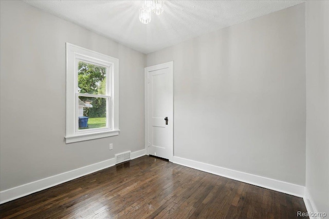 3345 Curwood St, Bloomfield Hills, MI 48329 - unfurnished room featuring dark wood-type flooring, baseboards, and a chandelier