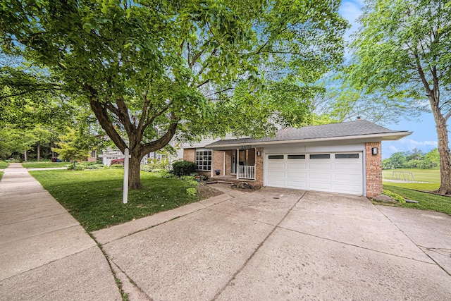 2402 Victoria Ave, Ann Arbor, MI 48104 - view of front of house with brick siding, a front lawn, an attached garage, and driveway