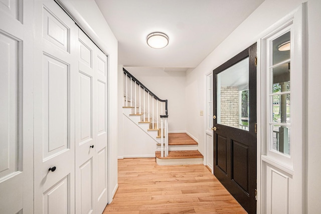 2402 Victoria Ave, Ann Arbor, MI 48104 - foyer entrance with light wood-type flooring, stairway, and baseboards