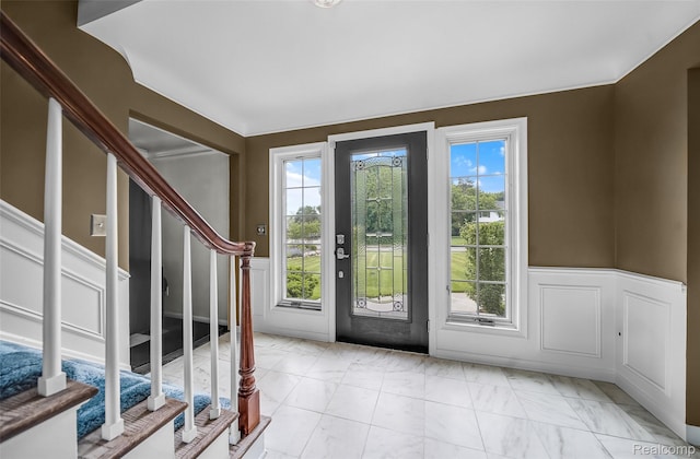100 Overhill Rd, Bloomfield Hills, MI 48301 - foyer featuring stairway, a wainscoted wall, light marble finish floors, and a decorative wall