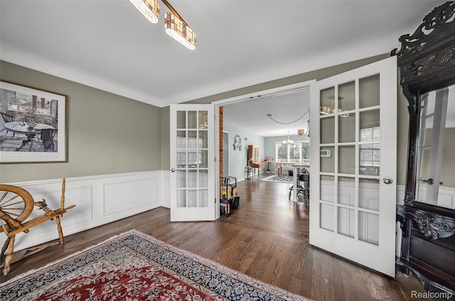100 Overhill Rd, Bloomfield Hills, MI 48301 - sitting room featuring french doors, wood finished floors, a chandelier, and a wainscoted wall