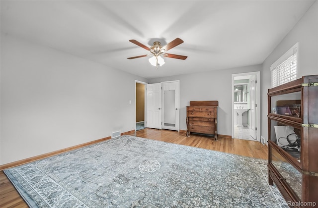 100 Overhill Rd, Bloomfield Hills, MI 48301 - bedroom with wood finished floors, baseboards, connected bathroom, and a ceiling fan