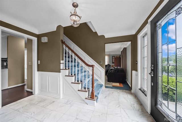100 Overhill Rd, Bloomfield Hills, MI 48301 - entrance foyer featuring marble look tile flooring, stairs, and wainscoting