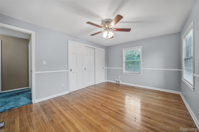 100 Overhill Rd, Bloomfield Hills, MI 48301 - unfurnished bedroom featuring a closet, wood finished floors, baseboards, and a ceiling fan