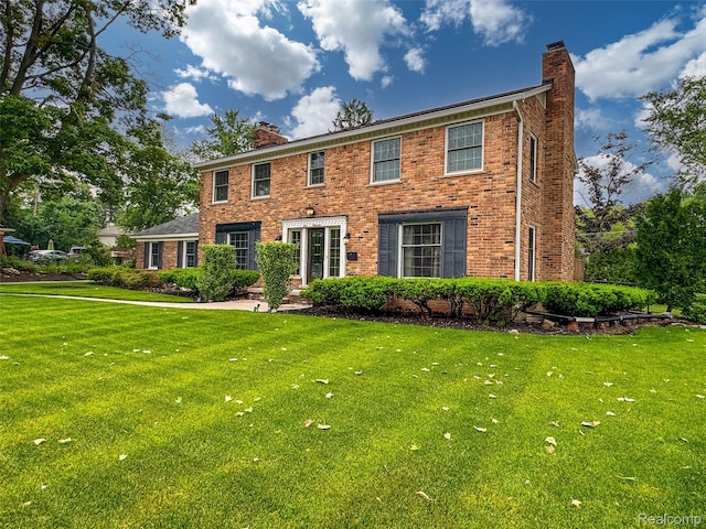 100 Overhill Rd, Bloomfield Hills, MI 48301 - colonial house with a chimney, a front lawn, and brick siding