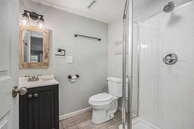 854 Upton Ave, Battle Creek, MI 49037 - bathroom featuring a stall shower, vanity, toilet, and baseboards