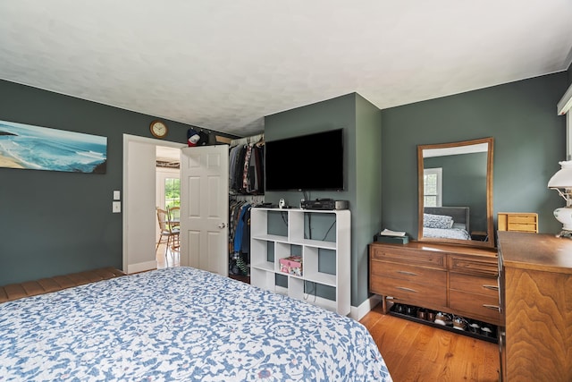 2961 E B Ave, Plainwell, MI 49080 - bedroom featuring wood finished floors, baseboards, and a textured ceiling