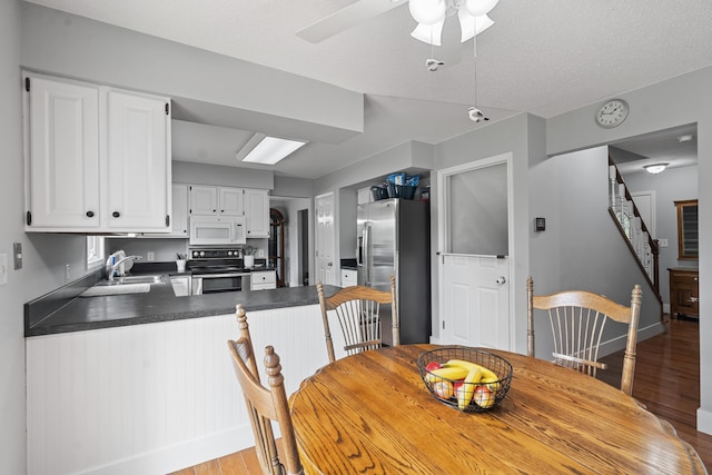 2961 E B Ave, Plainwell, MI 49080 - dining space featuring light wood-style flooring, baseboards, a ceiling fan, and stairway