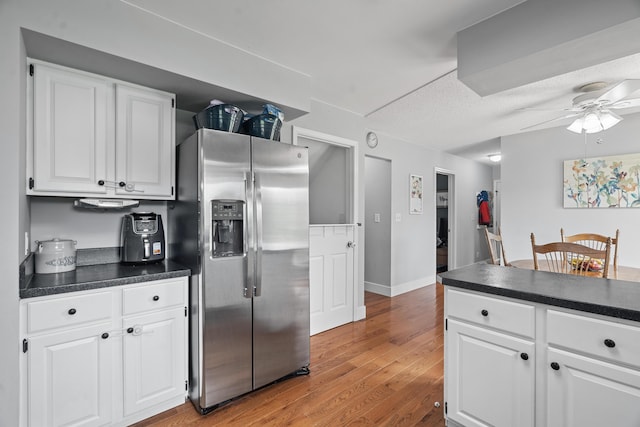 2961 E B Ave, Plainwell, MI 49080 - kitchen with stainless steel fridge, dark countertops, light wood-style floors, and ceiling fan