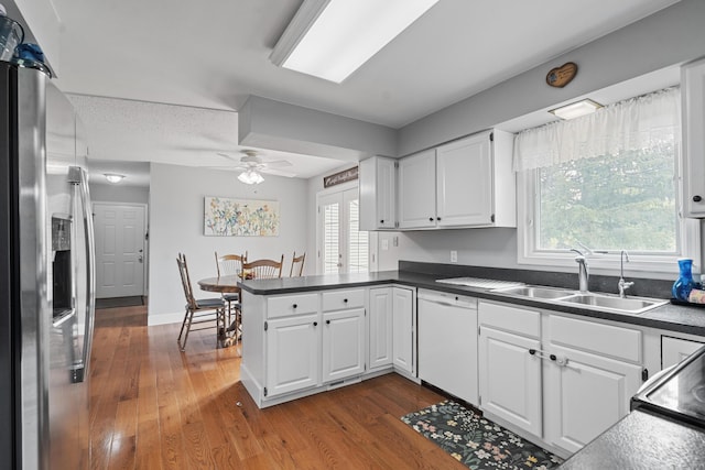 2961 E B Ave, Plainwell, MI 49080 - kitchen with stainless steel fridge with ice dispenser, a sink, dishwasher, a peninsula, and white cabinetry