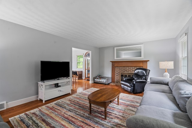2961 E B Ave, Plainwell, MI 49080 - living area with wood finished floors, baseboards, and a brick fireplace