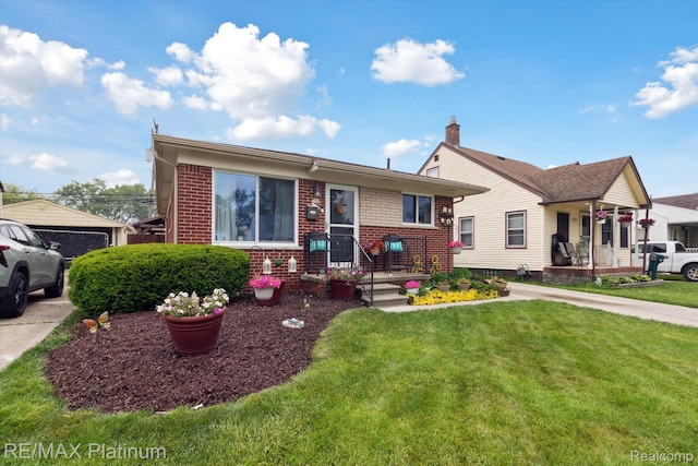 13471 Longtin St, Southgate, MI 48195 - view of front of property with brick siding and a front yard