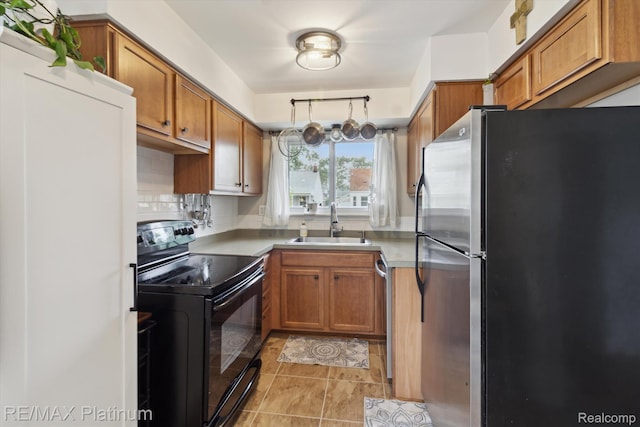 13471 Longtin St, Southgate, MI 48195 - kitchen with stainless steel appliances, a sink, brown cabinets, and light countertops