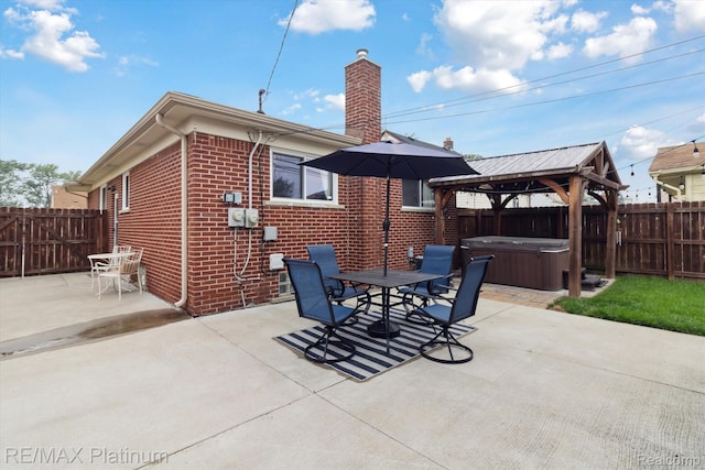 13471 Longtin St, Southgate, MI 48195 - back of house featuring a hot tub, brick siding, a chimney, a patio, and a fenced backyard