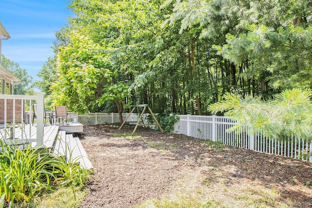 1653 Crab Apple Dr, Ypsilanti, MI 48198 - fenced backyard featuring a wooden deck and a playground