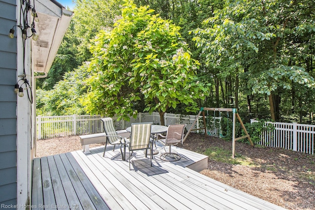 1653 Crab Apple Dr, Ypsilanti, MI 48198 - deck featuring outdoor dining space, a fenced backyard, and a playground