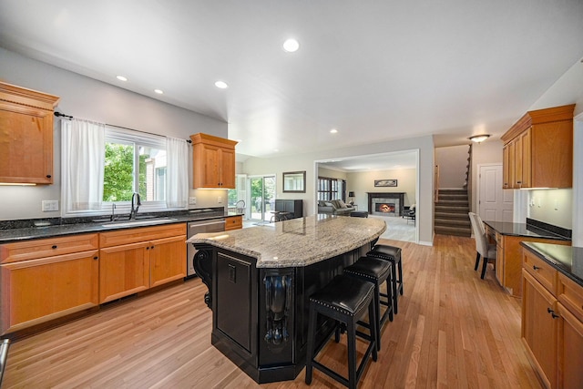 4251 Fleming Way, Plymouth, MI 48170 - kitchen with a sink, light wood-style flooring, a kitchen island, open floor plan, and a kitchen breakfast bar