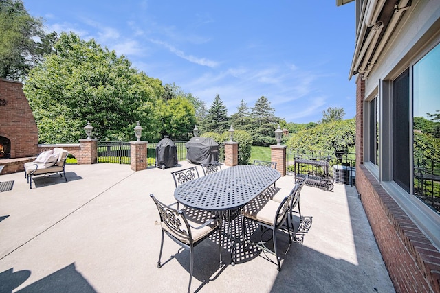 4251 Fleming Way, Plymouth, MI 48170 - view of patio featuring an outdoor brick fireplace, outdoor dining area, and area for grilling