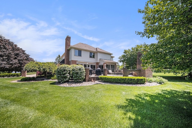 4251 Fleming Way, Plymouth, MI 48170 - back of house with a chimney, a lawn, and brick siding