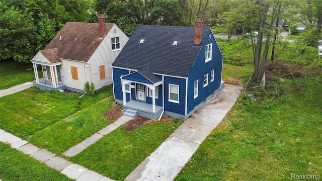 17594 Vaughan St, Detroit, MI 48219 - bungalow featuring a chimney, covered porch, a shingled roof, and a front lawn