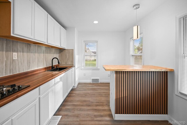 17594 Vaughan St, Detroit, MI 48219 - kitchen featuring wooden counters, a sink, dark wood-type flooring, white cabinets, and recessed lighting