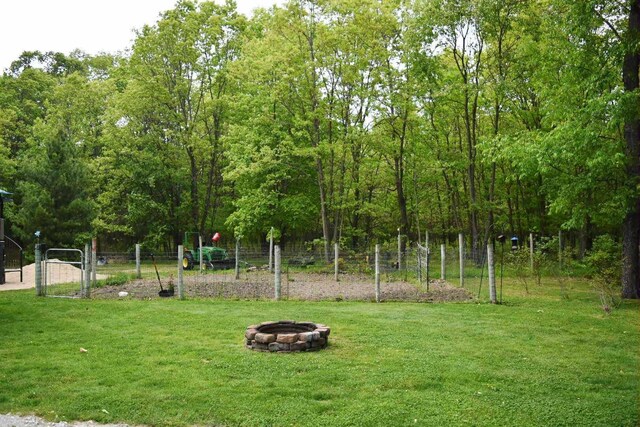 2735 Nestrom Rd, Muskegon, MI 49445 - view of yard featuring a fire pit, a playground, and a gate