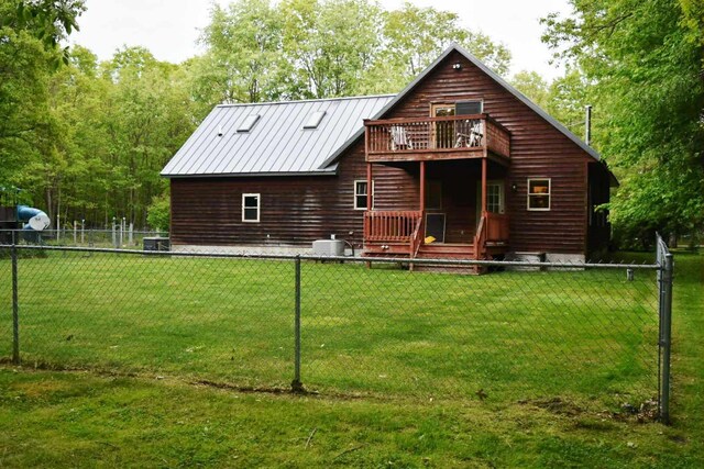 2735 Nestrom Rd, Muskegon, MI 49445 - rear view of property with a deck, central AC unit, and metal roof