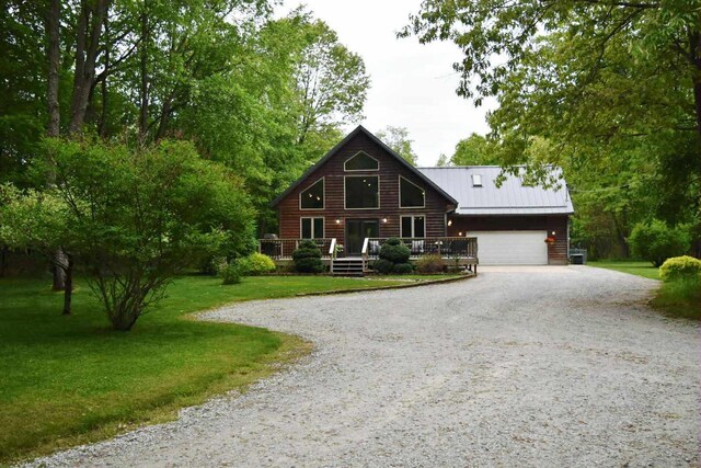 2735 Nestrom Rd, Muskegon, MI 49445 - cabin featuring driveway, a front lawn, metal roof, and a wooden deck