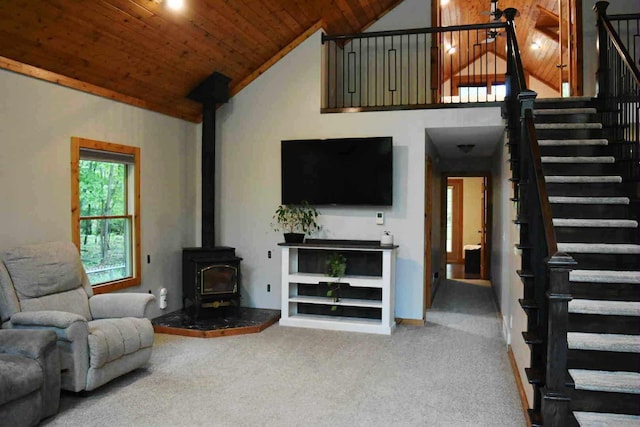 2735 Nestrom Rd, Muskegon, MI 49445 - living area featuring a wood stove, stairway, wooden ceiling, carpet, and high vaulted ceiling