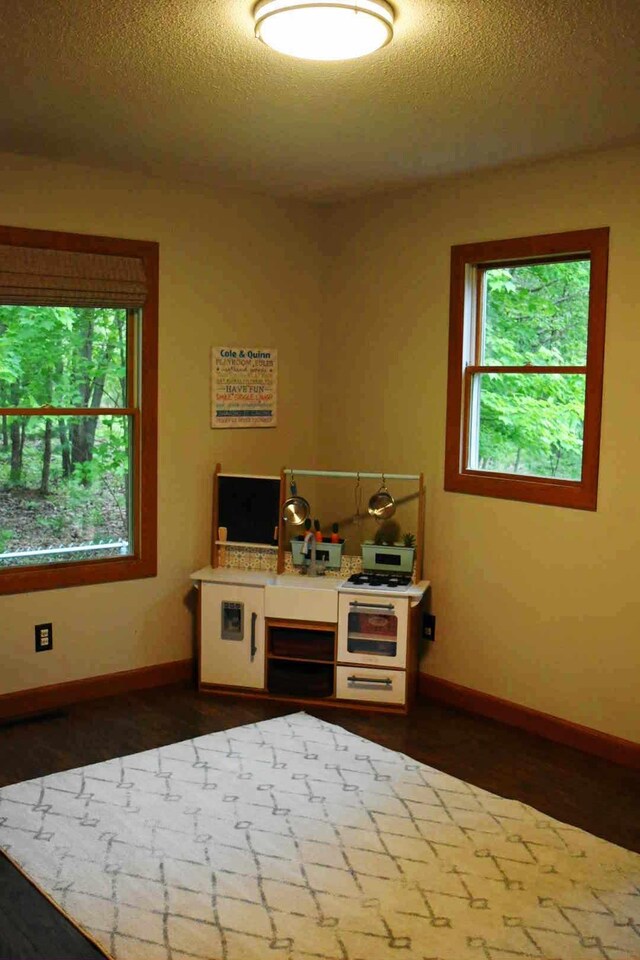 2735 Nestrom Rd, Muskegon, MI 49445 - kitchen with baseboards, a textured ceiling, white gas range, and light countertops