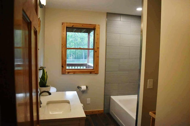 2735 Nestrom Rd, Muskegon, MI 49445 - bathroom featuring baseboards, vanity, wood finished floors, and recessed lighting