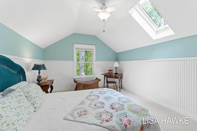 12857 Wilderness Trl, Grand Haven, MI 49417 - bedroom featuring vaulted ceiling, a skylight, a wainscoted wall, carpet floors, and ceiling fan