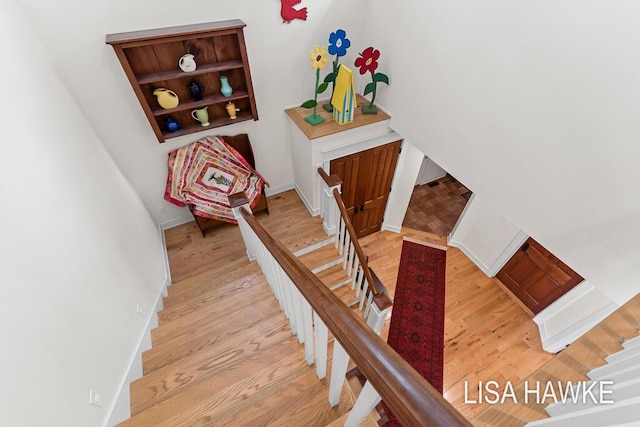 12857 Wilderness Trl, Grand Haven, MI 49417 - staircase with wood finished floors and baseboards