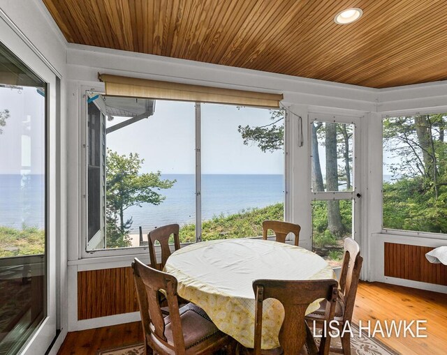 12857 Wilderness Trl, Grand Haven, MI 49417 - sunroom featuring a water view, wooden ceiling, and wood finished floors