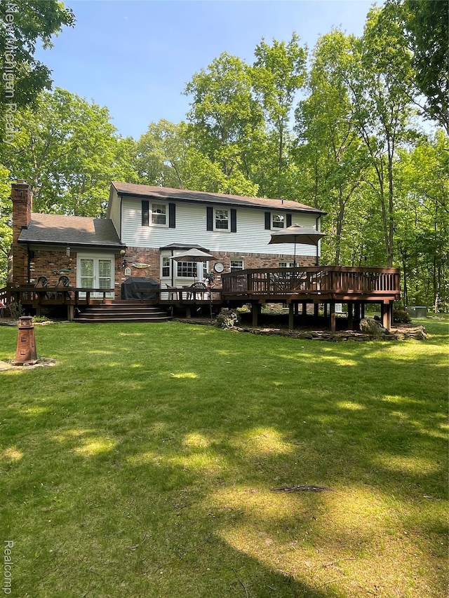 6567 Heaven Dr, Howell, MI 48855 - rear view of house featuring a deck, a yard, a chimney, and french doors